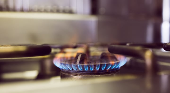 Closeup of burning gas on a gas stove in a custom kitchen remodel.